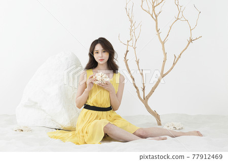 beautiful Asian model in yellow dress, spring beauty concept beautiful Asian model in yellow dress, spring beauty concept 77912469