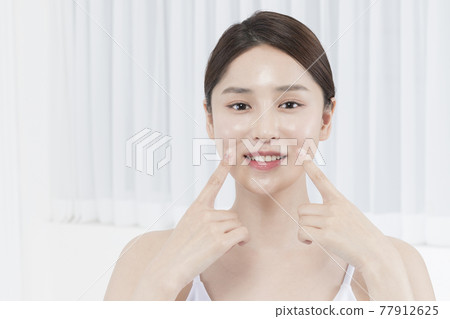 closeup of beautiful Asian model touching lips, beauty, surgery concept 77912625