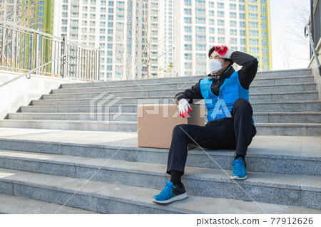 Asian delivery man working with mask Asian delivery man working with mask 77912626