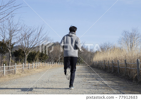 Asian man walking, strolling, jogging with mask Asian man walking, strolling, jogging with mask 77912683