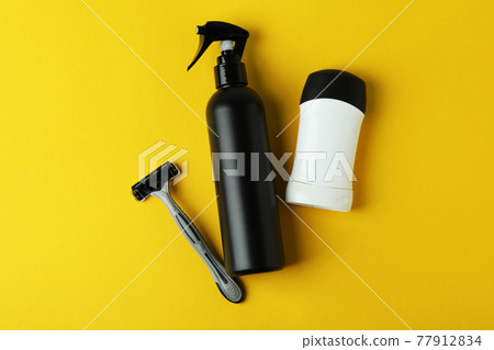 Concept of men's hygiene tools on yellow background 77912834