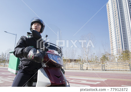 Asian food delivery male courier on motorcycle, scooter Asian food delivery male courier on motorcycle, scooter 77912872