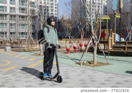 food delivery male courier riding electric scooter to deliver orders food delivery male courier riding electric scooter to deliver orders 77912928