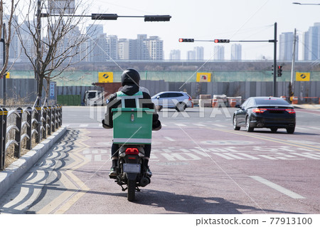 food delivery male courier riding motorcycle, scooter to deliver orders food delivery male courier riding motorcycle, scooter to deliver orders 77913100