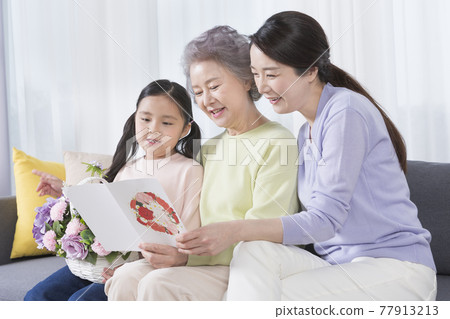 three generations of women, Asian grandmother, mother and grand daughter, birthday concept three generations of women, Asian grandmother, mother and grand daughter, birthday concept 77913213