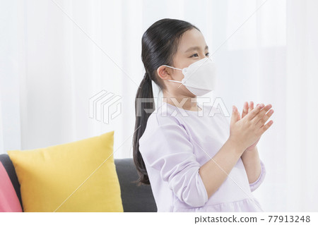 Asian girl child sanitizing hands 77913248