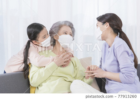 three generations of women, Asian grandmother, mother and grand daughter wearing mask three generations of women, Asian grandmother, mother and grand daughter wearing mask 77913260