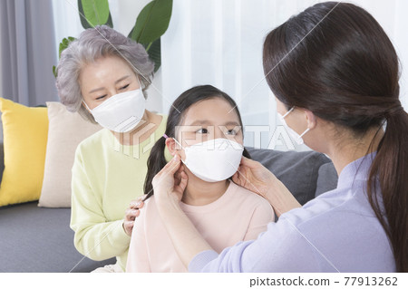 three generations of women, Asian grandmother, mother and grand daughter wearing mask 77913262