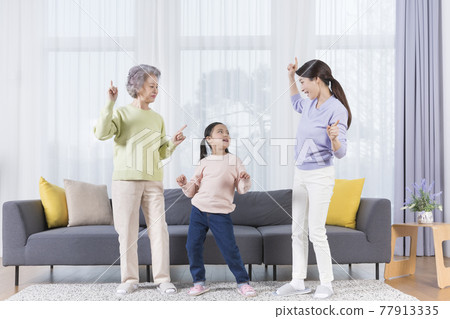 three generations of women, Asian grandmother, mother and grand daughter dancing three generations of women, Asian grandmother, mother and grand daughter dancing 77913335