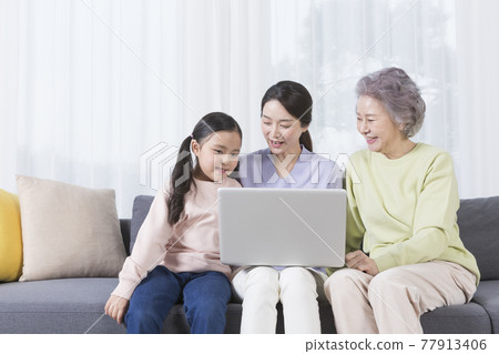 three generations of women, Asian grandmother, mother and grand daughter using laptop three generations of women, Asian grandmother, mother and grand daughter using laptop 77913406