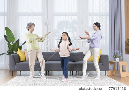 three generations of women, Asian grandmother, mother and grand daughter dancing three generations of women, Asian grandmother, mother and grand daughter dancing 77913418