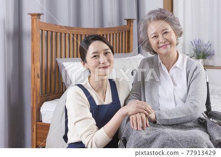 Asian caregiver and old woman at nursing home, hospital 77913429