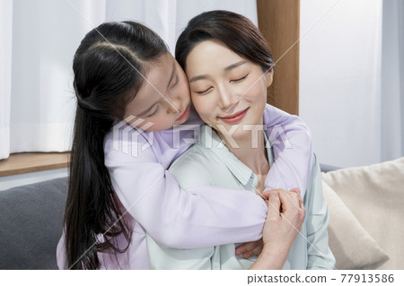Asian middle aged daughter hugging old mother from back 77913586