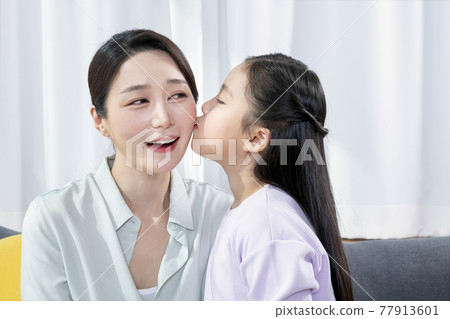 Asian mother and young daughter expressing love and care 77913601