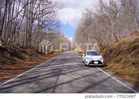Tsumagoi Panorama Line, a car parked on the shoulder of a mountain road Tsumagoi Panorama Line, a car parked on the shoulder of a mountain road 77913697