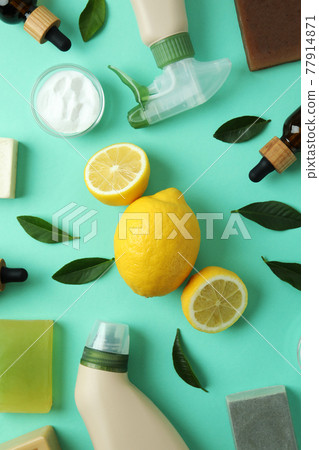 Cleaning concept with eco friendly cleaning tools and lemons on mint background 77914871