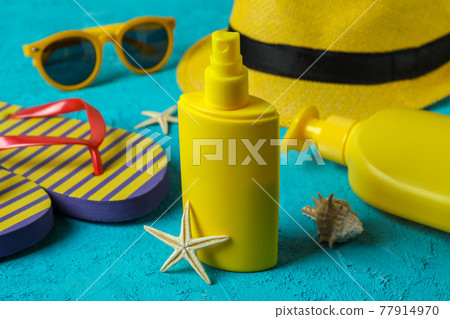 Summer concept with sunscreen on blue textured background 77914970