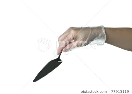 Female hand in disposable glove hold cake spatula, isolated on white background Female hand in disposable glove hold cake spatula, isolated on white background 77915119