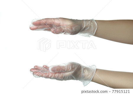 Female hands in disposable gloves hold something, isolated on white background Female hands in disposable gloves hold something, isolated on white background 77915121