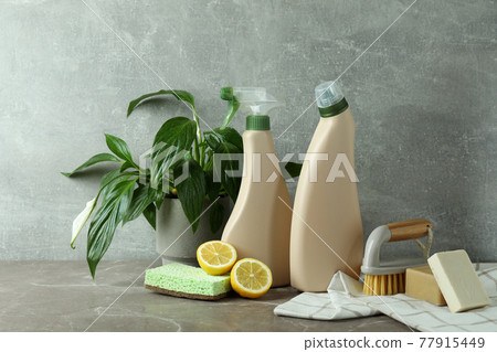 Cleaning concept with eco friendly cleaning tools on gray textured table 77915449