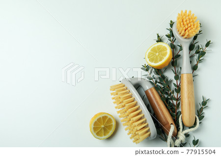 Eco friendly brushes, twigs and lemons on white background Eco friendly brushes, twigs and lemons on white background 77915504