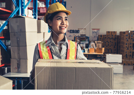 Female warehouse worker working at the storehouse 77916214