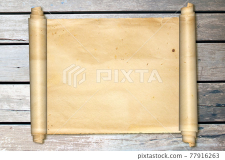 Scroll of old parchment on vintage wooden boards 77916263