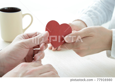 Men's and women's hands and heart objects 77916980