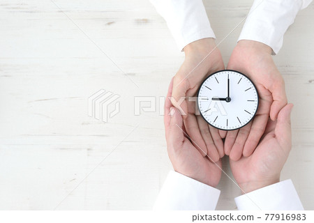 Watch wrapped in the hands of men and women 77916983