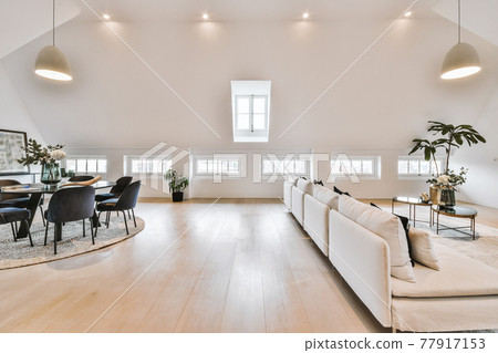 Attic apartment interior with round table Attic apartment interior with round table 77917153