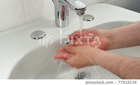 Unrecognisable man washing hands Unrecognisable man washing hands 77918534