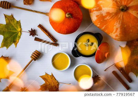 Autumn food. Pumpkin puree soup, leaves. Top view. Autumn harvest, pumpkins, leaves on grey as abstract background. Thanksgiving day. Flat lay. Autumn food. Pumpkin puree soup, leaves. Top view. Autumn harvest, pumpkins, leaves on grey as abstract background. Thanksgiving day. Flat lay. 77919567