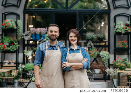 Owners of flower shop near showcase outdoor Owners of flower shop near showcase outdoor 77919636