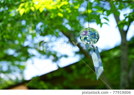 Wind chimes in the garden looking up at the roof 2 77919806