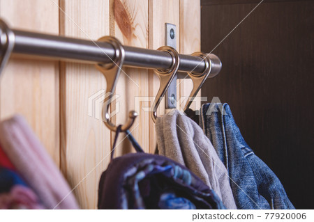 Kid's cloth hanginig on metal hooks. Close-up. Kid's cloth hanginig on metal hooks. Close-up. 77920006