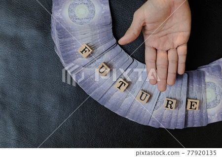 Close-up and selective focus right hands of fortune teller who supine hand for to invite people to choose tarot cards and listen to predictions about future destiny, Divine magic concept, top-view Close-up and selective focus right hands of fortune teller who supine hand for to invite people to choose tarot cards and listen to predictions about future destiny, Divine magic concept, top-view 77920135