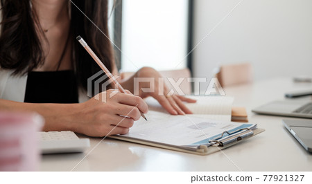 Business woman working in finance and accounting Analyze financial budget at home office Business woman working in finance and accounting Analyze financial budget at home office 77921327