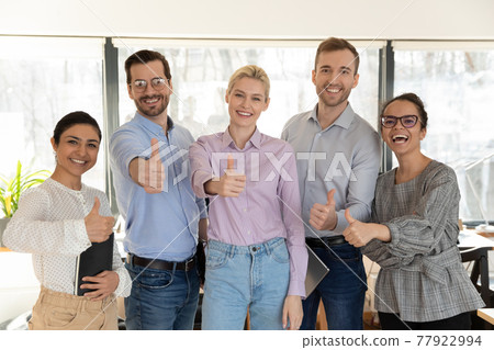 Portrait of successful diverse employees team showing thumbs up 77922994