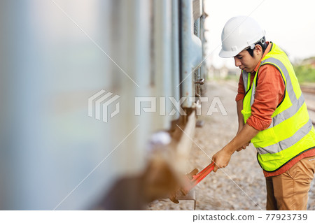 Engineer man checking train before service erformed various system checks. 77923739