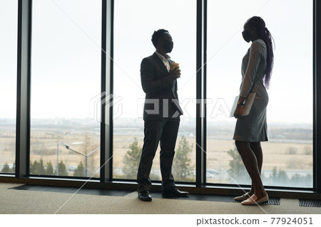 Two Business People by Window 77924051