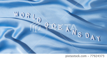 World oceans day banner in white letters on blue wave textile, june 8 holiday World oceans day banner in white letters on blue wave textile, june 8 holiday 77924373