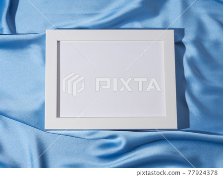 White empty mockup frame for text or picture on blue satin background White empty mockup frame for text or picture on blue satin background 77924378