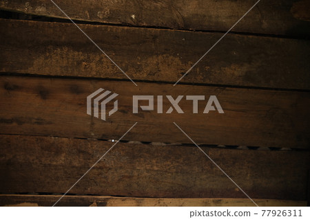 The texture of a wooden board on a wooden background. Wooden board with horizontal clapboard.. brown dirty burnt wood The texture of a wooden board on a wooden background. Wooden board with horizontal clapboard.. brown dirty burnt wood 77926311