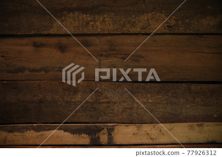 The texture of a wooden board on a wooden background. Wooden board with horizontal clapboard.. brown dirty burnt wood 77926312