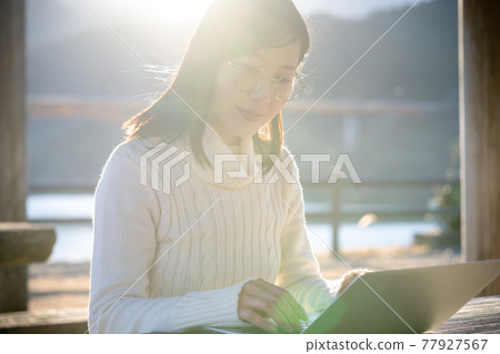 A woman worcation on the lakeside of a trip A woman worcation on the lakeside of a trip 77927567