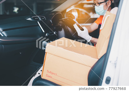 Delivery man employee driving car and using mobile phone during coronavirus pandemic situation Delivery man employee driving car and using mobile phone during coronavirus pandemic situation 77927668