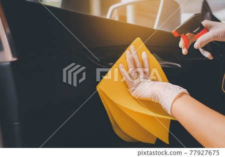 Woman hands using cloth cleaning inside a car,Safety and protect infection during covid-19 virus pandemic situation 77927675