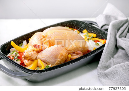 Raw organic uncooked whole chicken with bell pepper Raw organic uncooked whole chicken with bell pepper 77927803