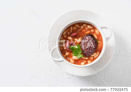 Spanish fabada on white table. Close up. 77928475