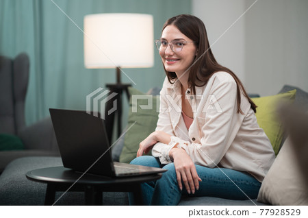 During lockdown in the covid-19 quarantine, the manager conducts a video conference from home using a laptop During lockdown in the covid-19 quarantine, the manager conducts a video conference from home using a laptop 77928529